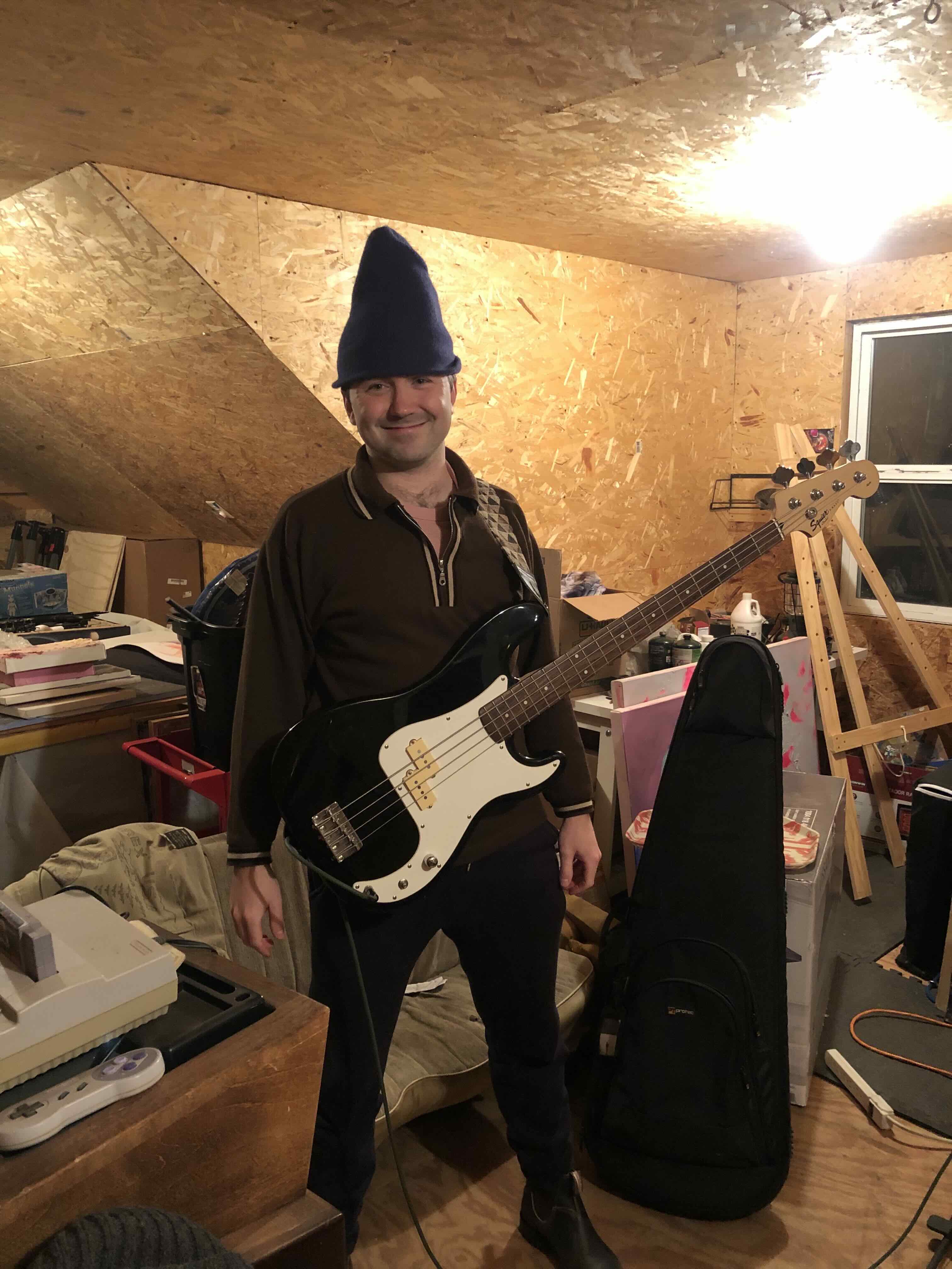 Me holding a Squier bass